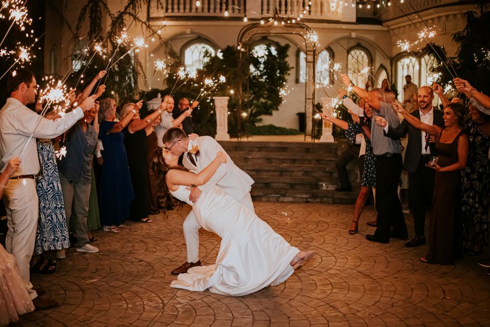 Bride and groom dipping with sparklers