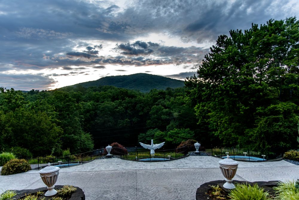 Pegasus statue with scenic mountain background at dusk