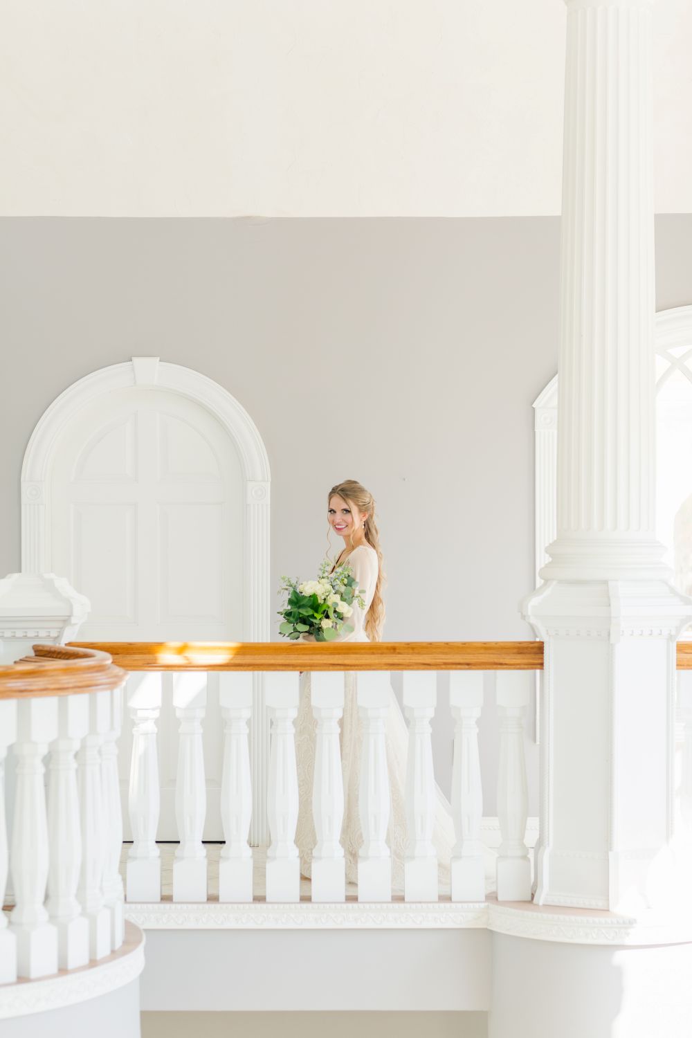Bride posing at the top of the grand staircase