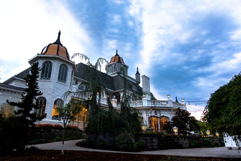 Exterior view of the estate from the pool area at dusk